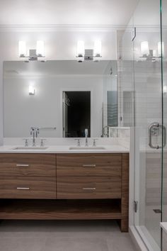 a bathroom with two sinks and a large mirror