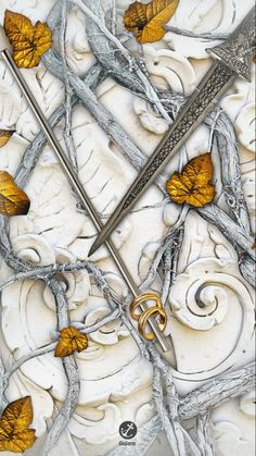 an artistic painting with gold leaves and scissors