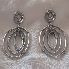 Fabulous And Fun! John Hardy Bamboo Drop Earrings In Sterling Silver Have A Door Knocker Design With 3 Nesting Oval Hoops In The Classic Jh Bamboo Design. These Earrings Are Long At 2 Inches And Have A Width Of 1 Inch. Each Of The Nesting Ovals Moves, And They All Hang From A Bamboo Designed Smaller Oval. These Have Posts And Brand New Jh Sterling Butterfly Backs. Each Earring Is Stamped On The Back Jh, 925, And "This Planted 6 Bamboos". The Butterfly Backs Are Stamped 925. These Are In Very Goo White Gold Metal Earrings For Formal Occasions, Timeless Silver Clip-on Earrings, Elegant Oval Silver Clip-on Earrings, Elegant Silver Oval Clip-on Earrings, Timeless Oval Silver Earrings, Timeless Silver Oval Earrings, John Hardy Jewelry, Bamboo Design, Door Knocker