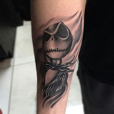 a man with a tattoo on his arm wearing a skull and crossbones design