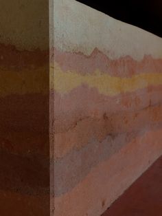 the corner of a wall that is painted with different colors