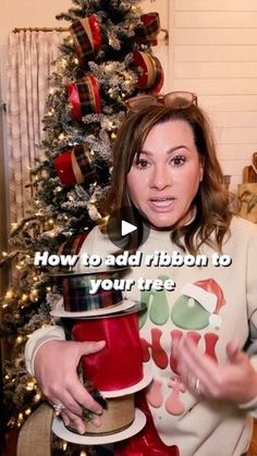 a woman holding a red fire hydrant in front of a christmas tree with the words how to add ribbon to your trees