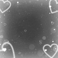 hearts are floating in the air on a black and white background