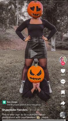 a woman in a black dress holding two pumpkins on her head