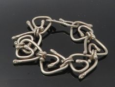 "925 Sterling Silver - Vintage Shiny Triangle Spiral Link Chain Bracelet - BT4486  925 Sterling Silver - Vintage Shiny Triangle Spiral Link Chain Bracelet - BT4486  Jewelry Type:         Bracelet   Metal Type:            925 Silver   Metal Size:             8\"  Stone Type:            N/A  Condition:              N/A  Jewelry Weight:     53.2 Grams  PLEASE NOTE: THIS ITEM IS PRE-OWNED. ALTHOUGH MOST ITEMS ARE IN VERY GOOD CONDITION, SOME MAY NEED CLEANING AND/OR MINOR REPAIRS. WE MAKE A VERY STRONG EFFORT TO UPLOAD CLEAR PICTURES. PLEASE INSPECT ALL PICTURES AND ASK ALL QUESTIONS YOU MAY HAVE PRIOR TO MAKING A PURCHASE. NOT ALL STONES ARE GENUINE, SOME ARE ENHANCED OR CREATED." Silver Bracelets With Hook And Links As Gift, Silver Bracelets With Hook And Links For Gift, Unique Sterling Silver Chain Bracelet, Sterling Silver Bracelet With Hook And Links, Silver Sterling Chain Bracelet With Hooks And Links, Silver Link Jewelry With Hook And Links, Bracelet Metal, Link Chain Bracelet, Diy Wire Jewelry