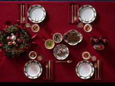 a table set for christmas with plates and silverware