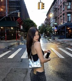 a woman standing in the middle of an empty street