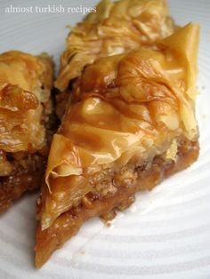 two pieces of pie sitting on top of a white plate