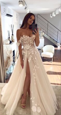 a woman taking a selfie in her wedding dress