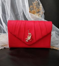 Elevate your evening ensemble with this stunning Red Suede Evening Clutch Bag, perfect for brides or bridesmaids at weddings and formal events. Featuring a chic envelope design adorned with delicate floral decoration, this handbag exudes elegance and sophistication. The vibrant red suede fabric adds a touch of luxury, while the compact size makes it convenient to carry your essentials in style. Make a statement and stand out with this exquisite clutch that will surely turn heads wherever you go. Wedding Handbag, Envelope Purse, Clutch Bag Wedding, Red Clutch, Envelope Design, Floral Decoration, Suede Fabric, Evening Clutch Bag, Red Suede