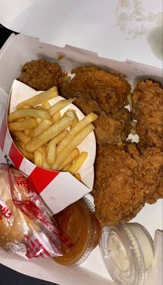 fried chicken and french fries in a takeout box