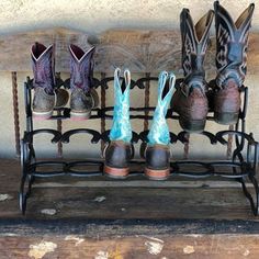 four pairs of boots are lined up on a rack