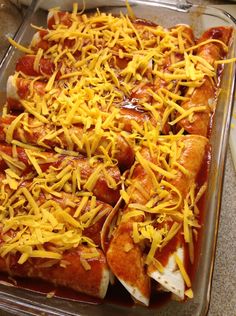 a casserole dish filled with cheese and hot dogs