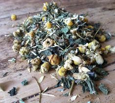 a pile of dried herbs sitting on top of a wooden table