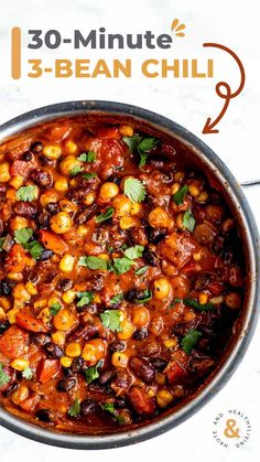 a pan filled with beans and garnish on top of a table