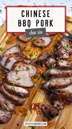 chinese bbq pork on a cutting board with chopsticks and garnishes