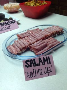 there are many different types of food on the table and one is labeled salami