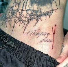 a woman's stomach with tattoos and writing on the bottom part of her body