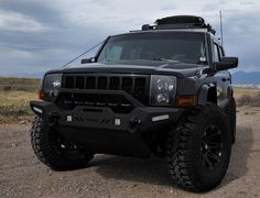 a black hummer truck parked in the desert