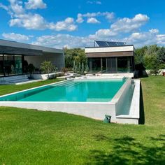 an empty swimming pool in the middle of a lawn