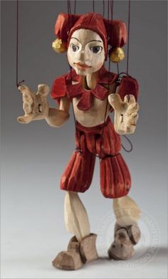 a figurine is hanging from strings with two hands