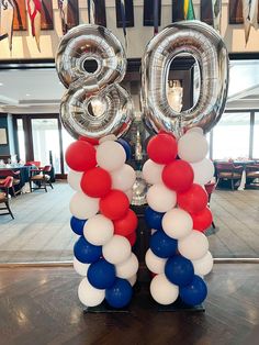 balloons are arranged in the shape of the number twenty eight, with red, white and blue colors