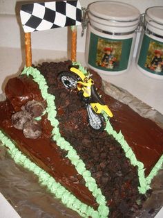 a cake shaped like a dirt bike is on display