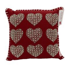 a red pillow with hearts on it