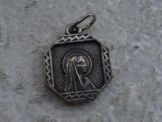 Religious antique French silvered catholic medal pendant medaillon medallion of Holy Mary of Lourdes. Measures are 0,63 x 0,76 inches ( 1,62 x 1,93 cm ) I bought this beautiful antique medal on a brocante ( fleamarket ) in France. I deliver all over the world. If you want more photos or information, you can contact me. If you don't have paypal, you can pay by bank transfer. Registered shipping is possible. Please take a look at my other items for sale.Registered shipping is possible and is costi Silver Miraculous Medal Pendant, Silver Pendant With Miraculous Medal, Miraculous Medal Medallion For Commemoration, Catholic Medals, Holy Mary, Bank Transfer, Virgin Mary, Items For Sale, Collectable Items