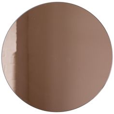 a round mirror is shown against a white background