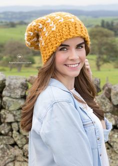 a woman wearing a yellow and white knitted hat