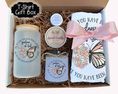 an open gift box containing two personalized items and a pink ribbon tied around it