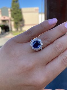 Genuine blue sapphire diamond statement ring. -Center stone is a gorgeous deep blue genuine sapphire. -Shape: Round/Oval. -Quality: Very high, Clean sapphire. -Carat weight: Approximately 3.39 carats. Setting/Diamonds: Halo vintage design with many brilliant round diamonds. - Average Diamond quality used: VS. - Diamond weight: 2 carats. -Metal: Solid 14k white gold. -Measurements: Sapphire halo face: 4.5mm. Graduated diamonds going down. Top to bottom: 1.2mm, mid 2mm, bottom diamond 2.2mm. Band Luxury Cluster Ring With Sapphire In Round Cut, Luxury Sapphire Cluster Ring With Round Cut, Sapphire Diamond Ring With Cushion Brilliant Cut, Oval Diamond White Sapphire Ring For Formal Occasions, Sapphire Diamond Ring With Cushion Cut, Luxury Cushion Cut Sapphire Ring With Halo Setting, Exquisite Sapphire Diamond Ring With Brilliant Cut, Dazzling Sapphire Ring With Brilliant Cut, Cushion Cut Sapphire Diamond Ring For Formal Occasions