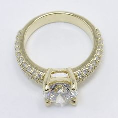 a yellow gold engagement ring with an oval cut diamond