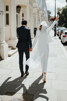 a newly married couple walking down the street