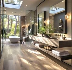 a large bathroom with a skylight above the bathtub and sink, surrounded by glass walls