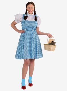 a woman in a blue and white dress holding a basket with a mouse on it