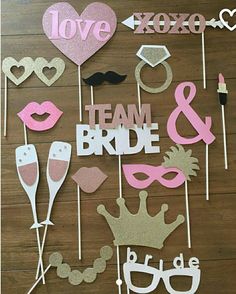 wedding photo booth props on a wooden floor with the words love, team bride and groom