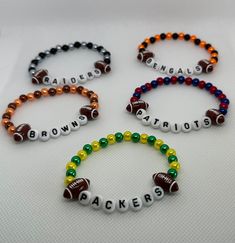 three bracelets with football beads and the word browns on them are arranged in different colors