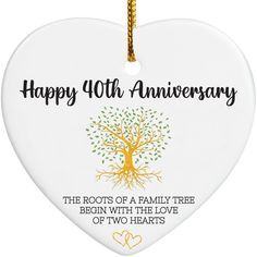 a white heart shaped ornament with an image of a tree and the words happy 10th anniversary