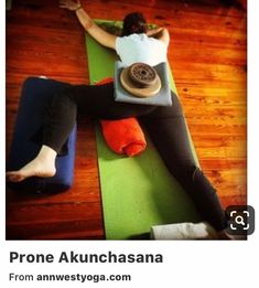 a woman sitting on top of a yoga mat