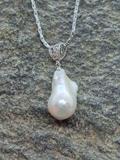 Stunning large white baroque pearl silver measures approximately 25 mm long by 15 mm wide.  Pearl is set on gorgeous oversized silver filigree bail. Pendant only available or purchase with high quality 20 inch nickel-free Italian stainless chain. Amazing luster with hints of gold, pink and blue depending on the light.  Photos are not filtered adding only some adjustment for brightness. I do my very best to depict all my pearls as accurately as possible. Please keep in mind, due to the unique bea Elegant Baroque Pearl Teardrop Pendant Jewelry, Elegant Baroque Pearl Jewelry In Pear Shape, Elegant Baroque Pearl Teardrop Pendant Necklace, White Pearl Pendant Jewelry, White Pearl Pendant Necklace, Elegant Wedding Necklace With Large Pendant, Elegant Large Pendant Necklace For Wedding, Classic Pearl Teardrop Pendant Jewelry, Teardrop Baroque Pearl Necklaces For Wedding