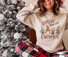 Introducing our Chillin' with my Gnomies sweatshirt featuring four adorable and festive gnomes! Embrace the cozy vibes and spread some holiday cheer with this charming and playful design. Made from premium quality material, this sweatshirt ensures your comfort while keeping you stylishly warm. Whether you're relaxing at home or attending a festive gathering, this sweatshirt is the perfect addition to your winter wardrobe. So, gather your gnomies and get ready to stay comfy and cute all season long! This is a unisex sweatshirt. Please check the size chart before placing your order.  Refunds are not given for ordering the wrong size. *The larger the sweatshirt, the larger the graphic.  Our printer sizes the graphics proportionate to the size of the shirt.   **Please understand that due to th Funny Christmas Sweater, Cute Gnomes, Funny Christmas Sweaters, Christmas Gnomes, Nordic Christmas, Sweatshirt Cute, Gildan Sweatshirts, Cozy Vibes, Cute Christmas