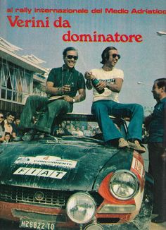 two men sitting on top of an old car