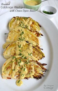 grilled cabbage wedges with onion dipper sauce on a white plate, ready to be eaten