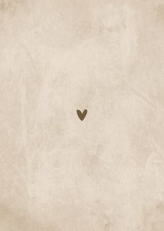 a heart shaped object in the middle of an old paper textured background with space for text