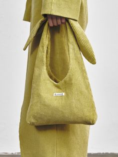 Editor's NotesECOMMAE's bag is simple and perfect for comfortable everyday wear.- Eye-catching tie knot shoulder strap detail- Logo patch on one side- Ribbed pattern fabric- Feminine and minimal styleMeasurements(in.)- Size: 10.63in. (W) / 6.89in. (L)- Strap: 9.45in. (L)Composition & Care- 100% Cotton- Lining: 100% nylon- Avoid heat and moisture- Dry cleaning is recommendedDesigner- by ECOMMAE Versatile Natural Color On-the-go Bag, Eco-friendly Shoulder Bag For On-the-go, Corduroy Bag, Knot Bag, Eco-friendly Bags With Adjustable Strap, Japandi Knot Bag, On-the-go Nylon Bag With Adjustable Strap, Denim Bag Diy, Next Fashion