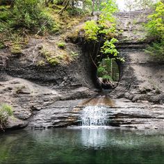 there is a small waterfall coming out of the cave