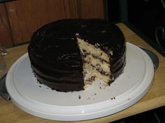 a chocolate cake with one slice cut out on a plate