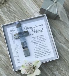 a gift box with a cross on it and a flower in the corner next to it